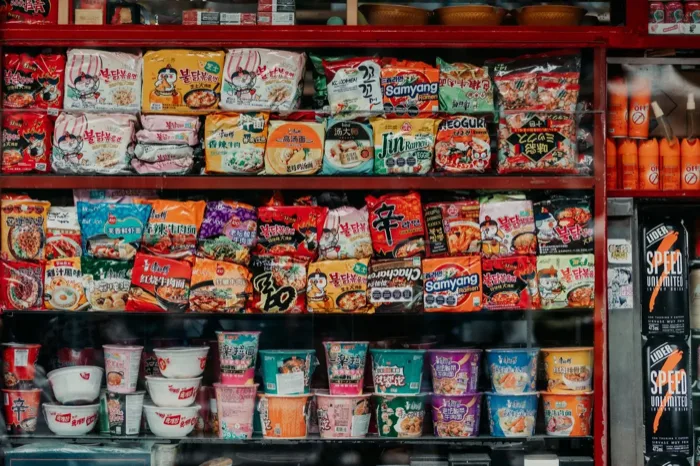 Shelves of packaged instant noodles and snacks