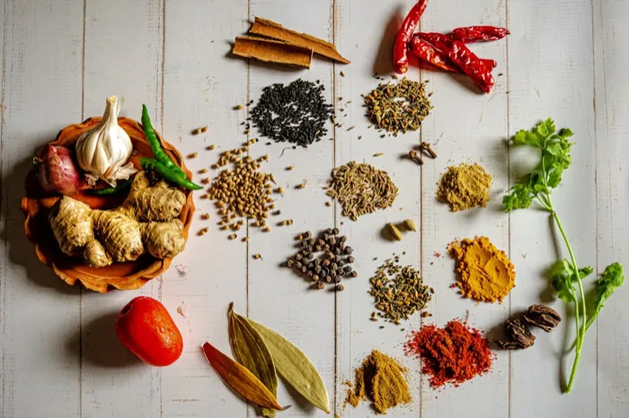 Indonesian spices — cloves, pepper, nutmeg on dark surface